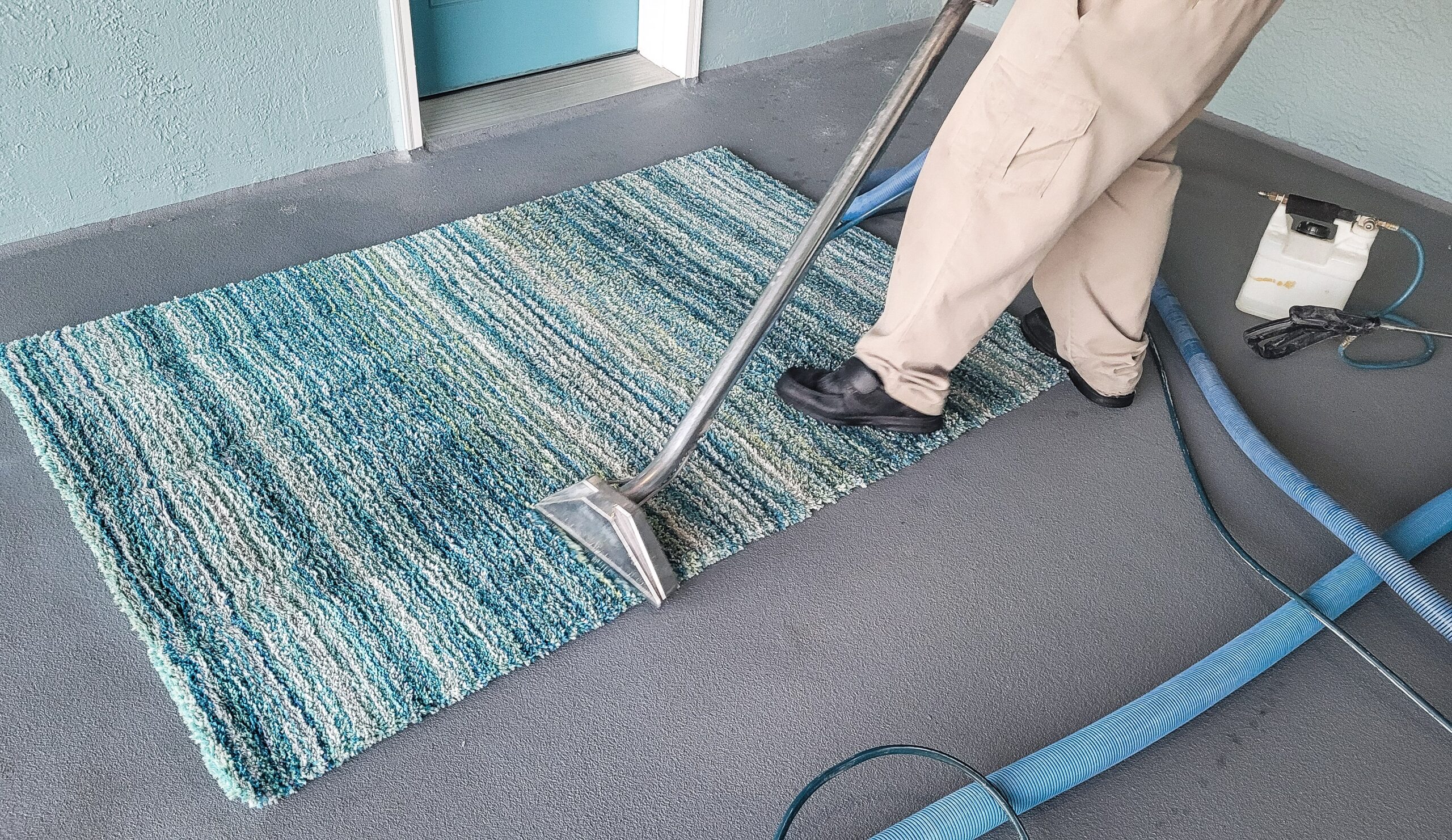 Cleaning carpet with vacuum cleaner.